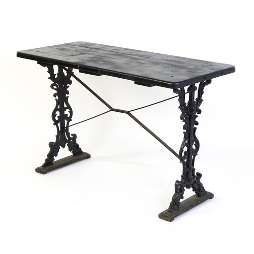 723 - A patio table with a three plank top above a cast iron base. 45