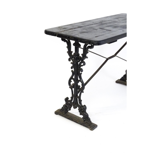 723 - A patio table with a three plank top above a cast iron base. 45