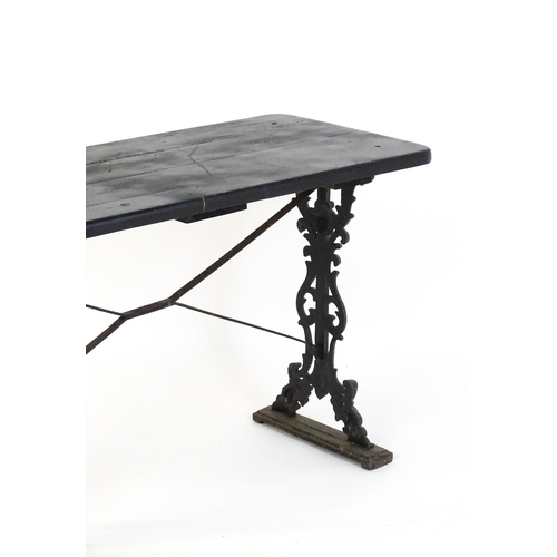 723 - A patio table with a three plank top above a cast iron base. 45