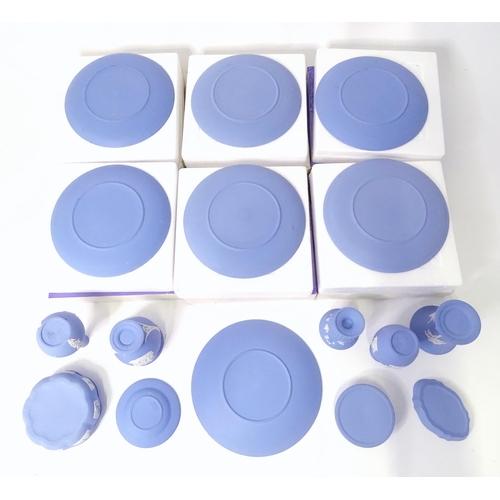 724 - A quantity of Wedgwood Jasperware to include Christmas plates, vases, candle holders, pin dishes, et... 