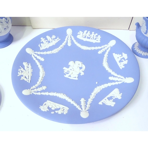 724 - A quantity of Wedgwood Jasperware to include Christmas plates, vases, candle holders, pin dishes, et... 