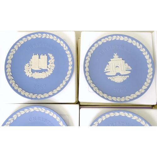 724 - A quantity of Wedgwood Jasperware to include Christmas plates, vases, candle holders, pin dishes, et... 