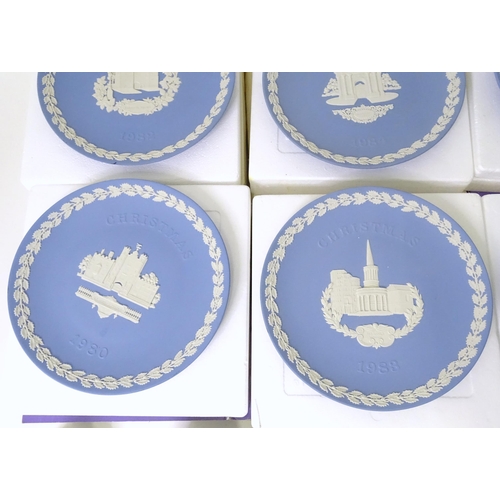 724 - A quantity of Wedgwood Jasperware to include Christmas plates, vases, candle holders, pin dishes, et... 