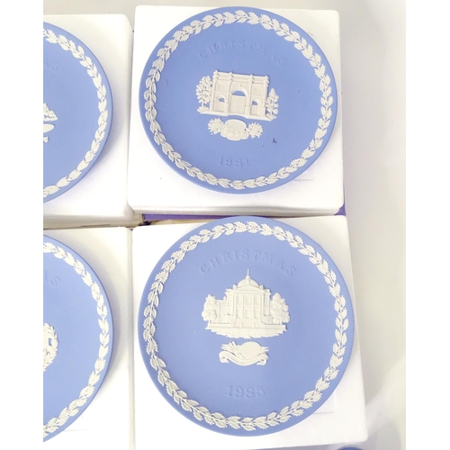 724 - A quantity of Wedgwood Jasperware to include Christmas plates, vases, candle holders, pin dishes, et... 