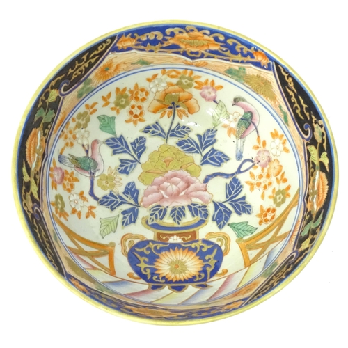 778 - An Oriental bowl decorated with flowers, foliage and birds. Approx. 4 3/4