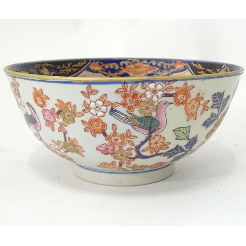 778 - An Oriental bowl decorated with flowers, foliage and birds. Approx. 4 3/4