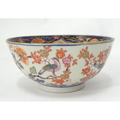 778 - An Oriental bowl decorated with flowers, foliage and birds. Approx. 4 3/4