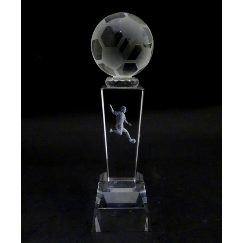 785 - A glass football trophy of tapering form with footballer detail to centre. Approx. 6 3/4