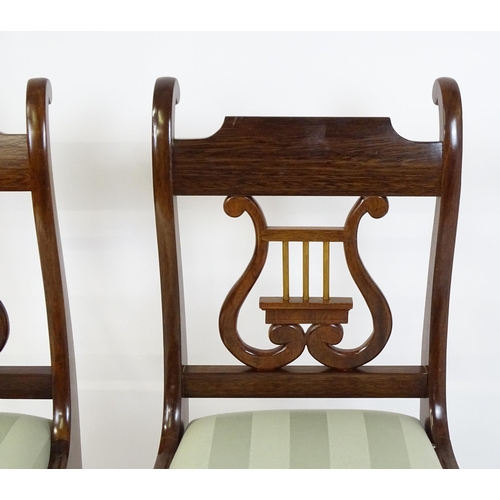 851 - A pair of mid  / late 20thC mahogany side chairs with lyre shaped back splats and raised on sabre le... 