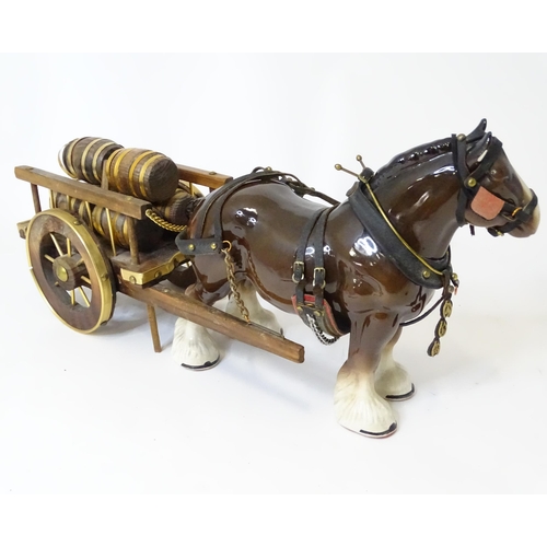 859 - A ceramic model of a dray horse with a wooden cart and barrels. Horse approx. 13 1/2