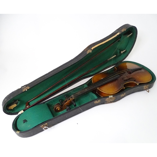 889 - A mid 20thC Bohemian violin, cased with two bows. The instrument approx 23 1/2