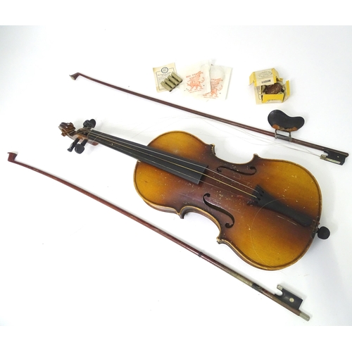 889 - A mid 20thC Bohemian violin, cased with two bows. The instrument approx 23 1/2