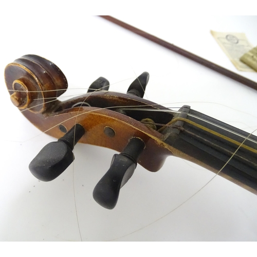 889 - A mid 20thC Bohemian violin, cased with two bows. The instrument approx 23 1/2