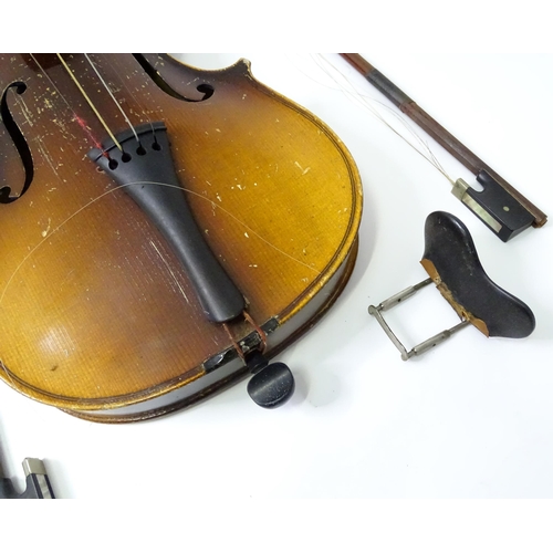 889 - A mid 20thC Bohemian violin, cased with two bows. The instrument approx 23 1/2