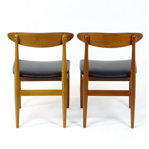 913 - Vintage / Retro: A pair of teak dining chairs raised on turned tapering legs. 20