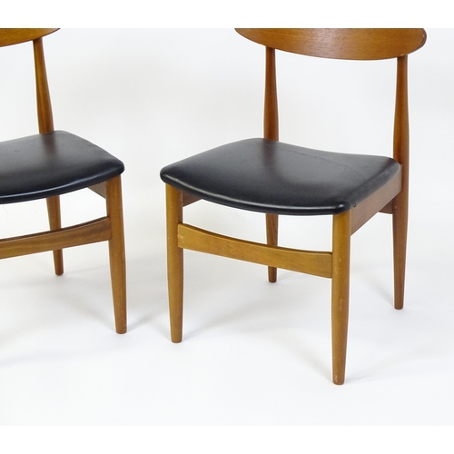 913 - Vintage / Retro: A pair of teak dining chairs raised on turned tapering legs. 20