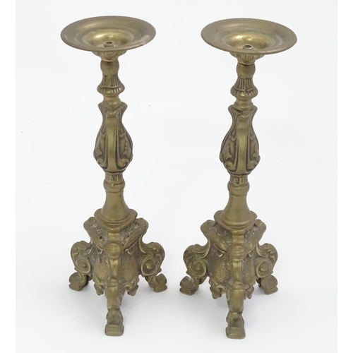 158 - A pair of cast candlesticks with scrolling detail. Approx. 12