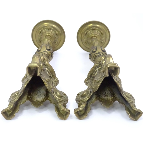 158 - A pair of cast candlesticks with scrolling detail. Approx. 12