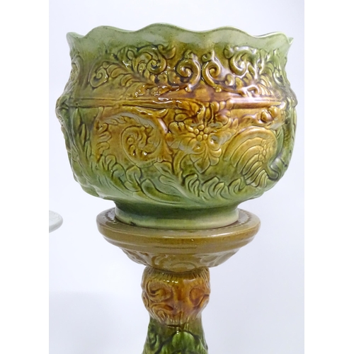 2 - A majolica jardiniere stand and planter with foliate decoration, signed England. Together with a jar... 