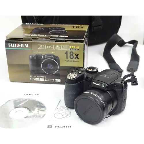 354 - A quantity of cameras, to include a boxed Fuji finepix S2500 bridge camera, together with examples b... 