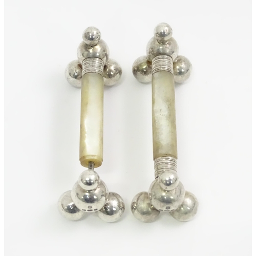 415 - A pair of silver and mother of pearl knife rests. Hallmarked Sheffield 1897 maker James Deakin & Son... 