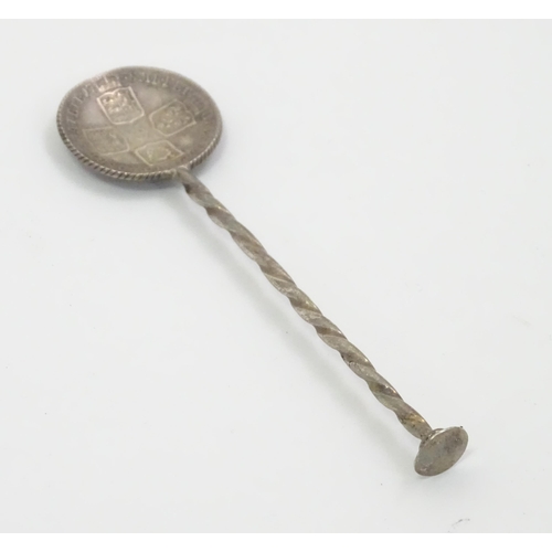 438 - A white metal salt spoon, the bowl with Geo II stylised coin detail. Approx. 3 1/2