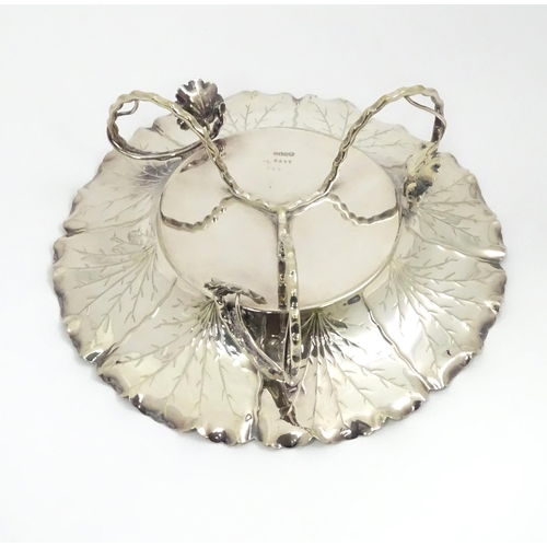 462 - A silver plate dish by Hukin & Heath of naturalistic form on three feet. Marked under and numbered 8... 