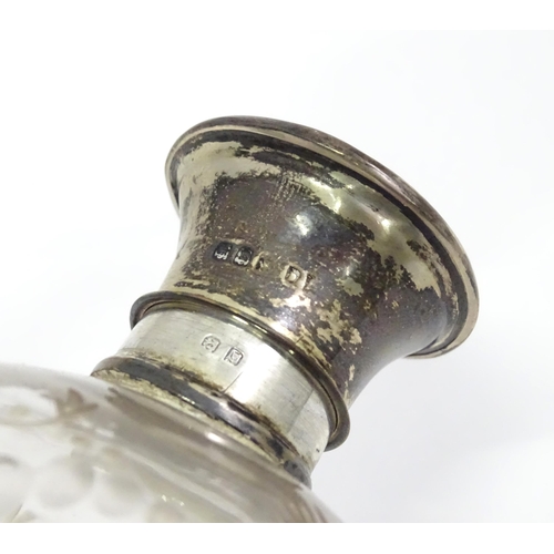 472 - A glass scent / perfume bottle with etched decoration with silver top hallmarked London 1918. Togeth... 