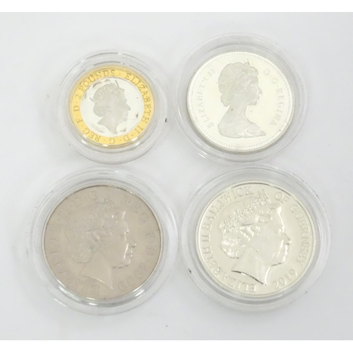 480 - Four commemorative coins , comprising a 1986-1986 Canada Dollar coin , a 1999-2000 five pounds coin ... 