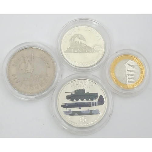 480 - Four commemorative coins , comprising a 1986-1986 Canada Dollar coin , a 1999-2000 five pounds coin ... 