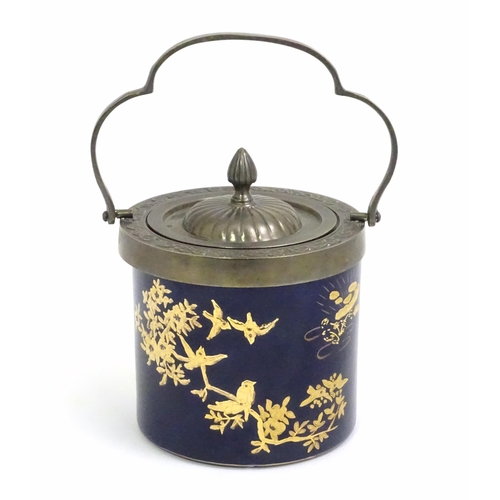 495 - A French biscuit barrel with blue ground decorated with gilt birds and flowers. Marked Limoge under.... 