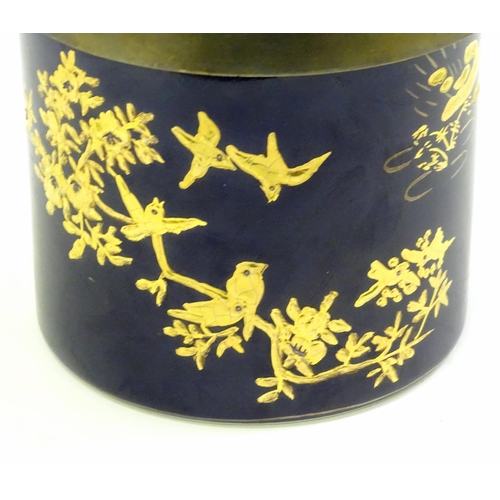 495 - A French biscuit barrel with blue ground decorated with gilt birds and flowers. Marked Limoge under.... 