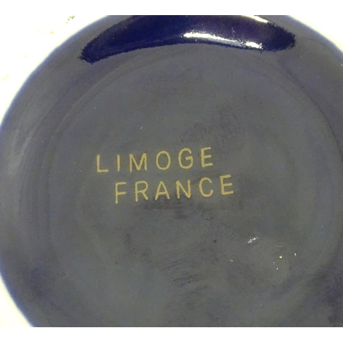 495 - A French biscuit barrel with blue ground decorated with gilt birds and flowers. Marked Limoge under.... 