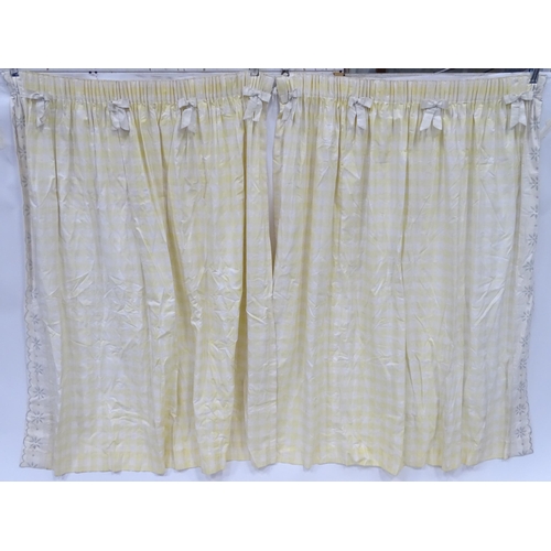 596 - A pair of curtains decorated in a yellow and white check pattern with bow detail. Together with a ma... 