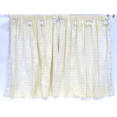 596 - A pair of curtains decorated in a yellow and white check pattern with bow detail. Together with a ma... 