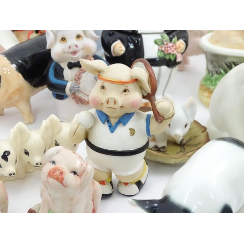 628 - A large quantity of assorted ceramic models of pigs to include examples by Nao, Border Fine Arts, Ro... 