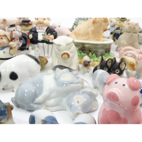 628 - A large quantity of assorted ceramic models of pigs to include examples by Nao, Border Fine Arts, Ro... 