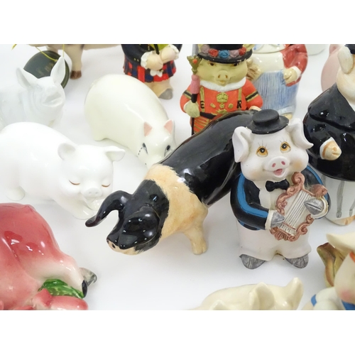 628 - A large quantity of assorted ceramic models of pigs to include examples by Nao, Border Fine Arts, Ro... 