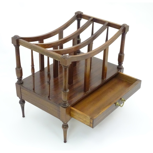 629 - A late 20thC mahogany Canterbury magazine rack together with an upholstered footstool, the largest a... 