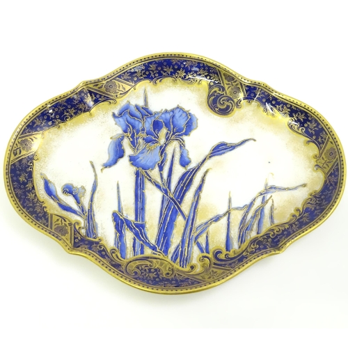 637 - A Doulton Burslem plate of shaped form decorated with Iris flowers. Marked under.