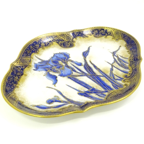 637 - A Doulton Burslem plate of shaped form decorated with Iris flowers. Marked under.