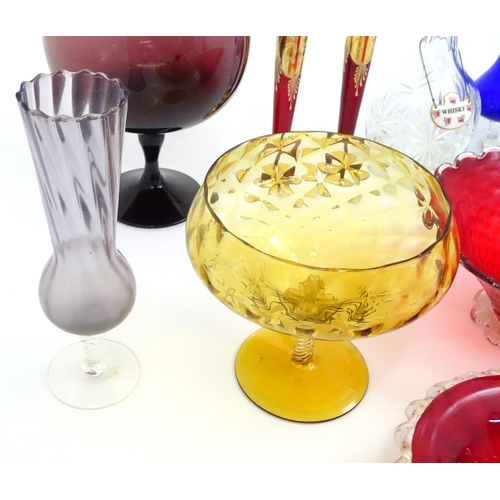 642 - A quantity of assorted glassware to include pedestal blue glass vases, candlesticks, decanters, pede... 