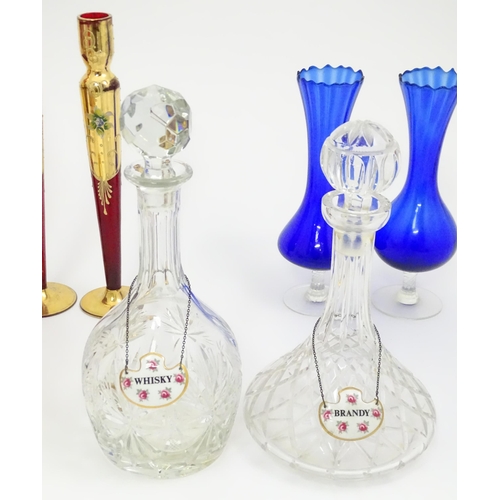 642 - A quantity of assorted glassware to include pedestal blue glass vases, candlesticks, decanters, pede... 