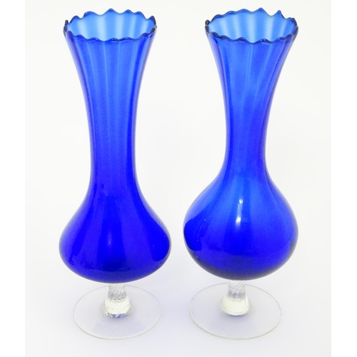 642 - A quantity of assorted glassware to include pedestal blue glass vases, candlesticks, decanters, pede... 