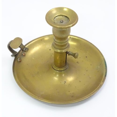 768 - A quantity of assorted brassware to include candlesticks, chamberstick, trenchart vase, bread toasti... 