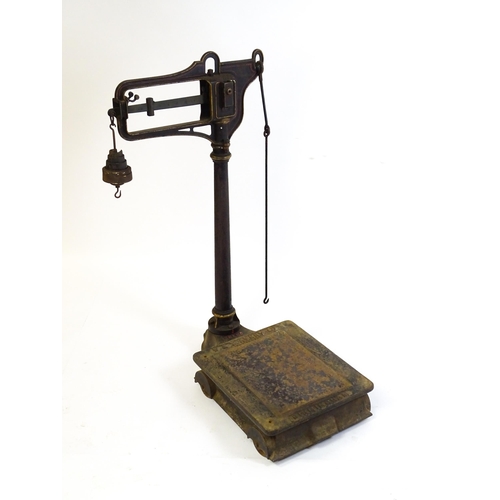 597 - A late 19thC W.T. Avery Pattern No. 139 cast iron platform weighing scale with jockey weighing chair... 