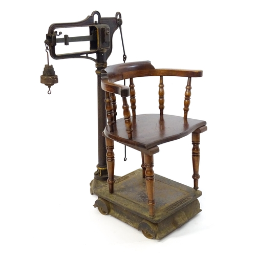 597 - A late 19thC W.T. Avery Pattern No. 139 cast iron platform weighing scale with jockey weighing chair... 