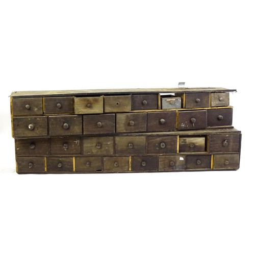 15 - Two rows of haberdashery / apothecary drawers, each set containing fifteen drawers each. 71