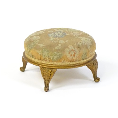 151 - An early 20thC circular footstool raised on four acanthus carved cabriole legs. 12