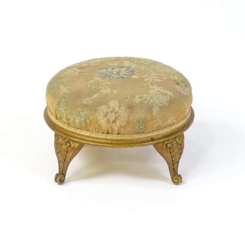 151 - An early 20thC circular footstool raised on four acanthus carved cabriole legs. 12